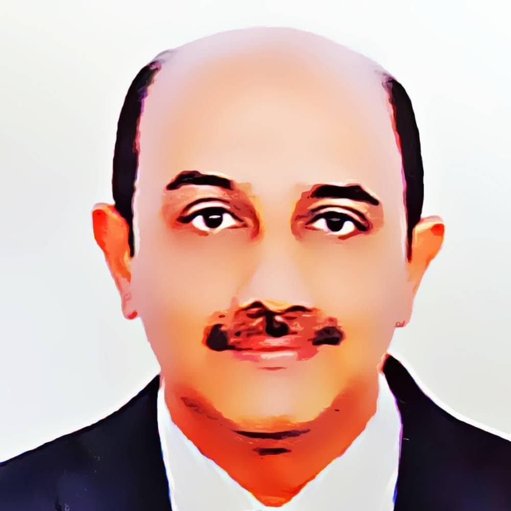 Portrait of a man wearing a suit and tie, focusing on a professional appearance, associated with Ayurvedic wellness and Panchakarma expertise.