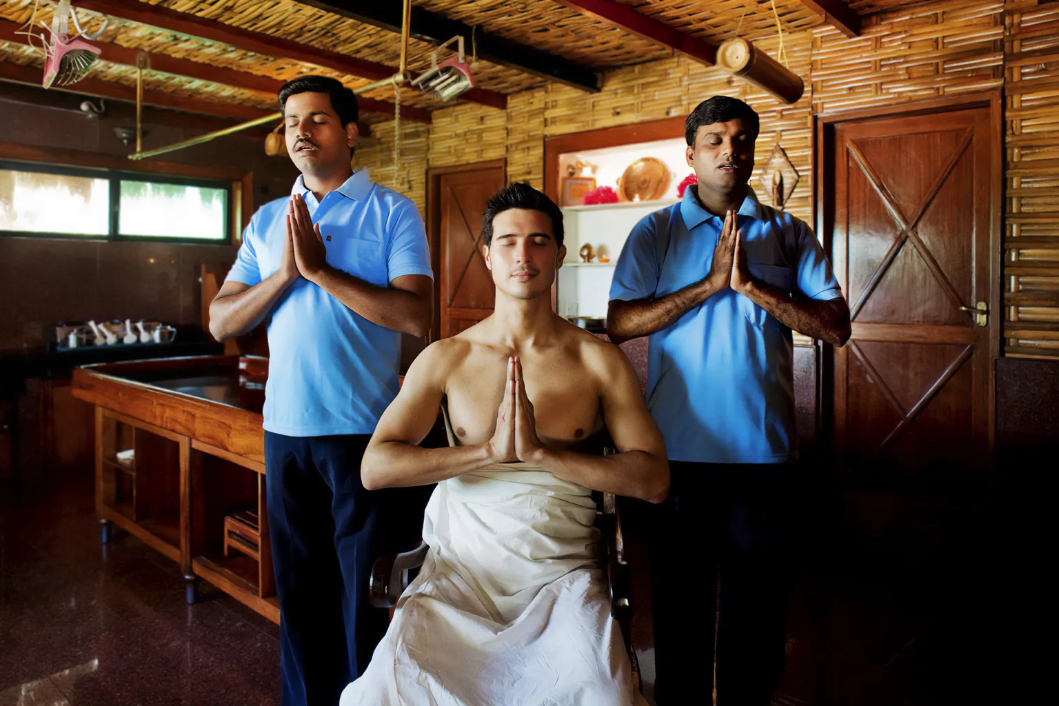 Man in an Ayurvedic Centre with two Indian Ayurvedic Therapists