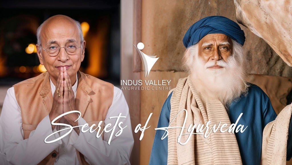 Two wise elders, embodying the spirit of Ayurveda, at Indus Valley Ayurvedic Centre. One gentleman, with hands in a namaste gesture, smiles gently, while the other, adorned in a blue turban with a white beard, gazes with serene wisdom. Together, they represent the timeless knowledge and compassion at the heart of IVAC, with the text ‘Secrets of Ayurveda’ highlighting their profound connection to holistic healing